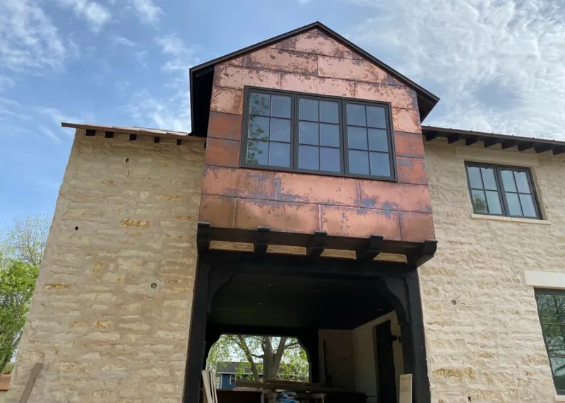 Copper metal panel facade on a stone building for Roof Repair in Mooresville
